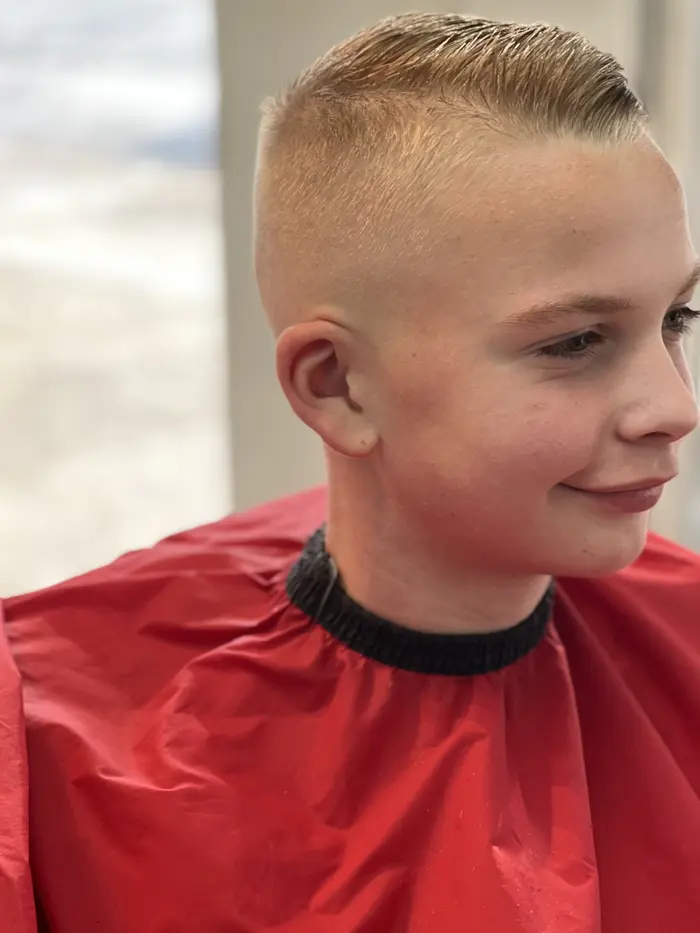 Boy's slicked-back cut with high skin fade