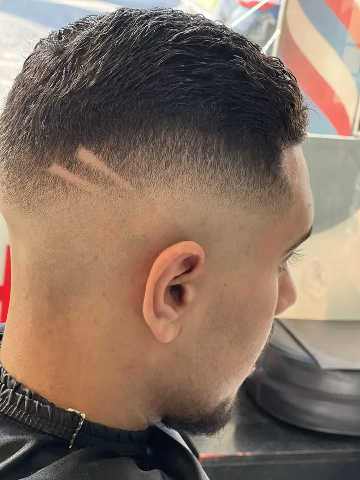 Skin fade with lightning bolt hair design