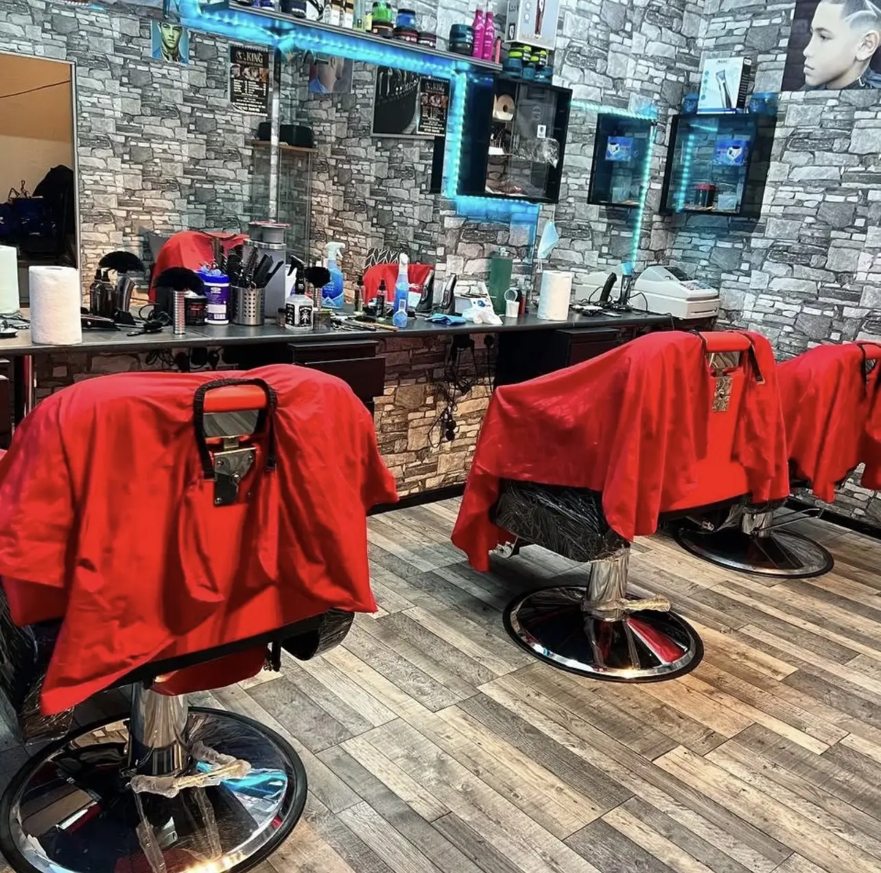 Inside King Turkish style barber — red barber chairs, stone wall and LED-lit mirrors